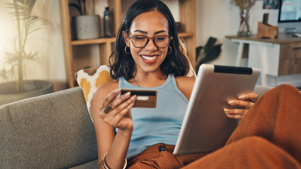 Woman making an online payment with her credit card on a tablet - Shift4